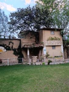 a large brick building with a tree on top of it at Qushi Shoncu Lodge in Huaylas