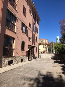 an empty street next to a pink building at Via Clitunno 24 in Foligno