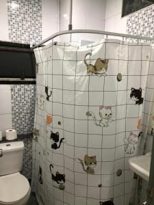 a bathroom with a shower with cats on the tiles at Den Nest Hostel KRABI in Ban Nong Chaeng +50 photos