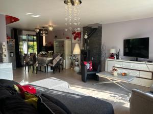 a living room with a couch and a dining room at Chez Mamie in Hautot-sur-Mer