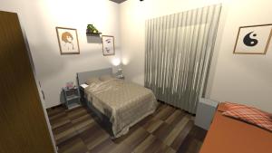 にあるOrt des Entstehensのベッドと窓のある小さな寝室