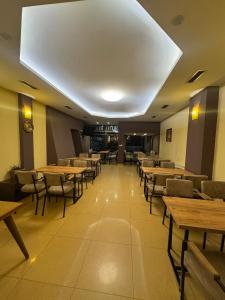 a dining room with wooden tables and chairs at Hotel Real in Prishtinë +47 photos