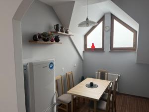 a kitchen with a small table and a refrigerator at Agroturystyka Kalinowe Ranczo in Radochów