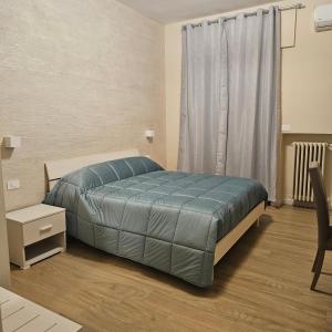 a bedroom with a bed and a window at IL CENTRO rooms in Cerignola