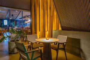 a wooden table and chairs in a restaurant at Noah's Forest Hotel by Tifakara in Fortuna