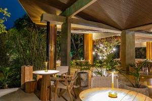 an outdoor patio with a table and chairs and lights at Noah's Forest Hotel by Tifakara in Fortuna