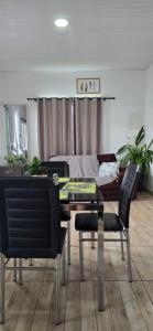 a living room with a table and chairs and a couch at Mecejana Home in Boa Vista