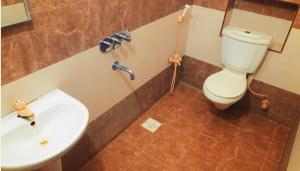 a bathroom with a sink and a toilet at RBS NEST in Tiruchchirāppalli +26 photos
