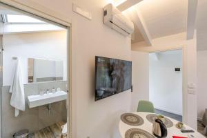 a bathroom with a sink and a table and a mirror at Agave Apartment in Vico Equense