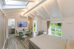 a bedroom with a bed and a table and chairs at Agave Apartment in Vico Equense
