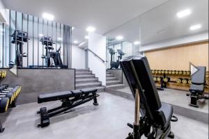 a gym with a bench and dumbbells at Hevenia Klifowa 5 B Apartament 33 in Rewal