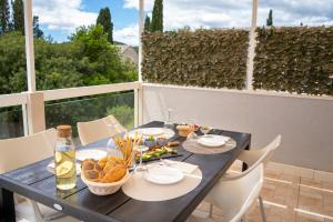 a black table with food on it on a balcony at Apartment Darka 1 in Sumartin