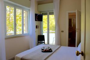 a bedroom with a bed with a tray of fruit on it at King Hotel in Cesenatico