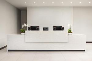 a white reception counter in a lobby with two toasters at Home2 Suites By Hilton Cleveland, TN in Cleveland +41 photos
