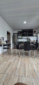 a kitchen and dining room with a table and chairs at Mecejana Home in Boa Vista