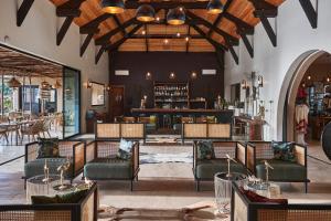 a restaurant with chairs and a bar in the background at Yokan Lodge in Palmarin