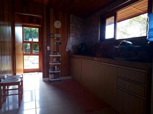 a kitchen with a counter and a window and a table at Casa de Campo in Caldas +4 photos