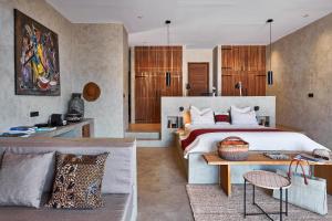 a bedroom with a large bed and a couch at Yokan Lodge in Palmarin +56 photos