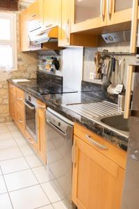 丰罗穆Altitude 1711 - Terrasse en hyper-centre的配有木质橱柜和台面的厨房