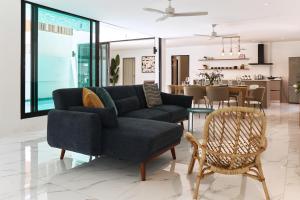 a living room with a couch and a dining room at Modern Villa 4-BR, Breeze - 10 min walk to NaiYang beach in Nai Yang Beach