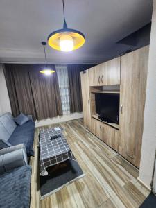 a living room with a couch and a flat screen tv at Arel's Home in Prizren