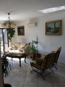 a living room with a couch and a table and chairs at Affittacamere CasaBattistini in Monti di Licciana Nardi