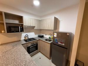 a small kitchen with a stove and a refrigerator at Apartment in Victoria in Lima