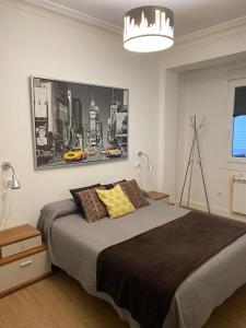 Un dormitorio con una cama grande y una lámpara de araña. en Precioso apartamento en A Coruña, en A Coruña 13 fotos más