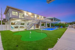 a house with a putting green in front of it at Surfstream Edge in Marathon Airport