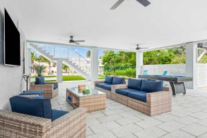 a patio with couches and a pool table and a table at Surfstream Edge in Marathon Airport