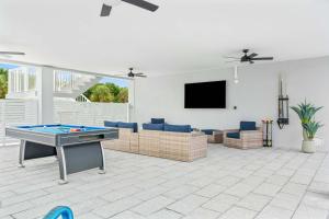 a living room with a pool table and a flat screen tv at Surfstream Edge in Marathon Airport +57 photos