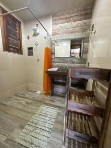 a bathroom with a sink and a mirror at Recanto do Amor in Cascavel