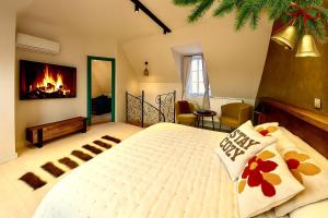a bedroom with a large bed with a fireplace at Casa Albastră by Casa Otto in Sighişoara