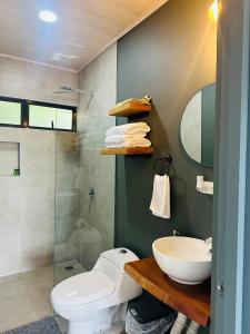 a bathroom with a toilet and a sink and a shower at Casa Ola Ini Studio Playa Grande in Playa Grande