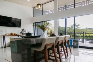 a dining room with a large table and chairs at Casa Ola Ini Studio Playa Grande in Playa Grande