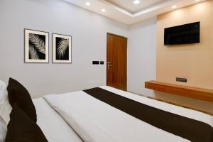 a bedroom with a bed and a television on a wall at Hotel O THE SHAURYA INN in Bhauli