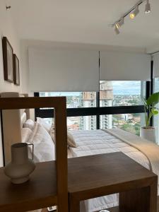 a bedroom with a bed and a large window at More deluxe sol in Asuncion