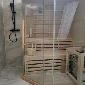 a shower with a glass enclosure in a room at Pensiunea Balta Lazar in Alexandria +12 photos