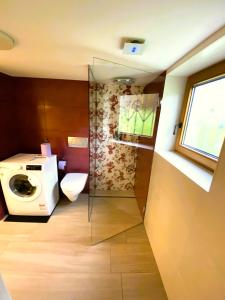 a bathroom with a washing machine and a toilet at "Nestl" in Bad Häring +13 photos