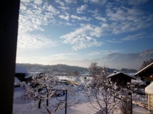 a view of a snow covered village with mountains in the background at "Nestl" in Bad Häring