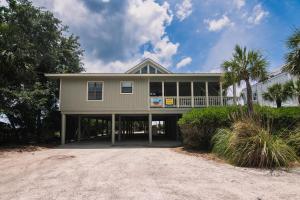 a house on a beach with palm trees at Crowfield in Edisto Beach