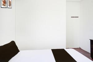 a bedroom with a white bed and a fireplace at SPOT ON Ap Logde in Māharjhari