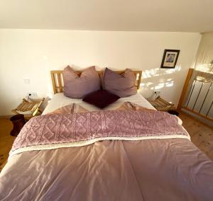 a bed in a bedroom with a woman laying on it at "Nestl" in Bad Häring