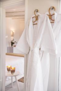 a white robe hanging on a rack in a room at Posada Arenas in José Ignacio