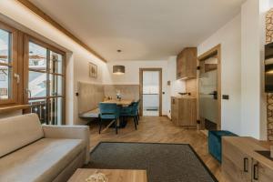 a living room with a couch and a table at Miraval Perathoner Andreas in Ortisei