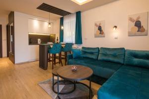 a living room with a couch and a table at Vila Vujic Tara in Kaludjerske Bare