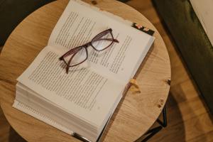 a pair of glasses sitting on top of a book at Miraval Perathoner Andreas in Ortisei