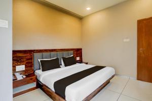 a bedroom with a large bed in a room at Hotel O Maharashtra Darbar Gonde in Pādli