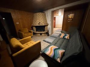 a living room with a couch and a fireplace at Holiday home on the edge of the woods in Kemijärvi