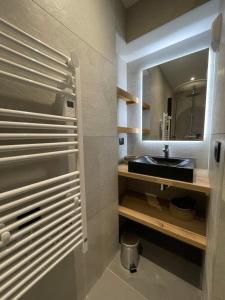 a bathroom with a sink and a mirror at Appartement Haut de Gamme neuf avec deux terrasses - 6 personnes - App 102 in Saint-Sorlin-dʼArves